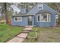 Close-up of a charming home with a blue exterior, bay window, and inviting front entrance at 7957 Elm St, Louviers, CO 80131