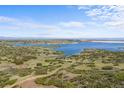 Expansive lake view surrounded by rolling hills and prairie at 7615 Lemon Gulch Way, Castle Rock, CO 80108