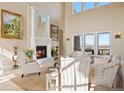 Elegant living room with fireplace and ample natural light at 7615 Lemon Gulch Way, Castle Rock, CO 80108