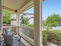 Inviting porch with seating area, white railings, and pleasant neighborhood views at 13244 Kearney St, Thornton, CO 80602