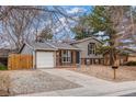 Charming home with a brick and siding exterior, a driveway, and a manicured front lawn at 2145 S Lewiston St, Aurora, CO 80013