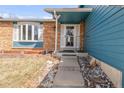 Welcoming front entrance with brick accents and covered porch at 4121 S Andes Way, Aurora, CO 80013