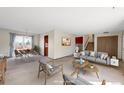 Bright living room with a dining table and furniture, virtually staged at 4121 S Andes Way, Aurora, CO 80013