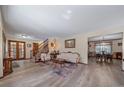 Open-concept living room with hardwood floors and seamless access to the dining area at 5753 S Kittredge St, Centennial, CO 80015