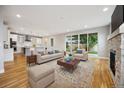 Bright, open-concept living room with hardwood floors, fireplace, and sliding glass doors to the yard at 779 Kohlor Dr, Lafayette, CO 80026