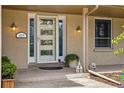 Inviting front door with decorative glass and sidelights, accented by outdoor lighting and a cozy porch at 6219 S Krameria St, Centennial, CO 80111