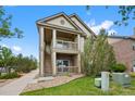 Inviting two-story condo featuring brick accents, dual balconies, and landscaped grounds at 23451 E 5Th Dr # 203, Aurora, CO 80018