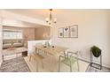 Bright dining room features modern chandelier, artwork, and seating at 13086 E Alaska Ave, Aurora, CO 80012