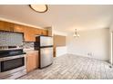 Well-lit kitchen with stainless steel appliances and modern tile backsplash at 13086 E Alaska Ave, Aurora, CO 80012