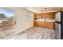 Bright kitchen features ample cabinetry, stainless steel refrigerator, and access to the deck at 13086 E Alaska Ave, Aurora, CO 80012