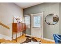 Charming entryway features a unique cabinet and a decorative cowhide rug near a white door at 3736 N Mariposa St, Denver, CO 80211