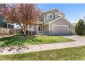 Charming home with a two car garage, neutral paint, and lush landscaping at 19064 E Oak Creek Way, Parker, CO 80134