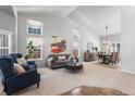 Spacious living room with large windows and high ceilings; great for entertaining at 19064 E Oak Creek Way, Parker, CO 80134