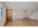 Inviting living room featuring hardwood floors, front door, and stairway to the upper level at 9255 E Lehigh Ave # 194, Denver, CO 80237