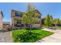 Attractive two-story home with a well-manicured lawn, stone accents, and convenient two-car garage at 5758 Echo Park Cir, Castle Rock, CO 80104