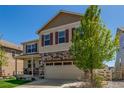 Two-story home with stone accents, a well-maintained lawn, covered porch, and convenient two-car garage at 5758 Echo Park Cir, Castle Rock, CO 80104