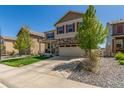 Suburban home with mature trees, concrete driveway, rock garden, and charming curb appeal at 5758 Echo Park Cir, Castle Rock, CO 80104