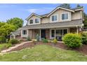 Charming home featuring manicured landscaping, a covered porch, and a classic exterior at 5991 S Eudora Way, Centennial, CO 80121