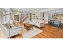 Bright living room with hardwood floors, a cozy fireplace, and large windows at 5991 S Eudora Way, Centennial, CO 80121