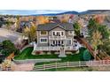 Aerial view showcasing a home with a spacious backyard deck and mountain views at 9665 W Danzig Pl, Littleton, CO 80127