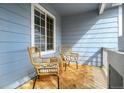 Inviting covered porch with stylish wicker chairs and a cozy outdoor rug at 9765 Merimbula St, Highlands Ranch, CO 80130