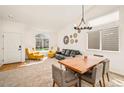 Bright living room with vaulted ceilings, neutral carpet, and ample natural light at 9765 Merimbula St, Highlands Ranch, CO 80130