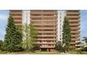 Brick building exterior, with balconies and landscaping at 4570 E Yale Ave # 306, Denver, CO 80222