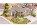 Beautiful home with a well-maintained lawn, complemented by mature trees and an attached two-car garage at 8922 S Tuscany Ln, Highlands Ranch, CO 80130