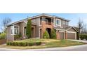 Charming two-story home featuring brick accents, manicured landscaping, and a welcoming front entrance at 8922 S Tuscany Ln, Highlands Ranch, CO 80130