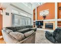Bright living room boasts high ceilings, large windows, a cozy fireplace, and comfortable seating at 333 Mesa St, Brighton, CO 80601