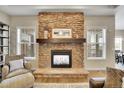 Close up of a stone fireplace and hearth with windows on both sides at 27615 E Moraine Dr, Aurora, CO 80016