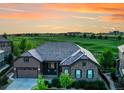 Beautiful single-Gathering home with stone accents and a well-manicured lawn backing to a golf course at 27615 E Moraine Dr, Aurora, CO 80016