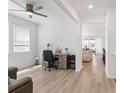 Bright living room featuring wood floors and a large window, creating a warm and inviting atmosphere at 23936 E River Front Dr, Aurora, CO 80019
