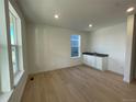 Bright bonus room with hardwood floors and a wet bar at 585 Twilight St, Erie, CO 80516