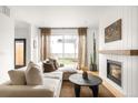Comfortable living room features a large sectional sofa, fireplace with wooden mantel, and access to the backyard at 3422 S Grant St, Englewood, CO 80113