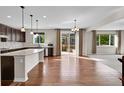 Bright kitchen boasts granite countertops, stainless appliances, hardwood floors and outside access at 12762 Fisher St, Englewood, CO 80112