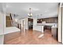 Open floor plan showing the kitchen and staircase with hardwood floors and a kitchen island at 12762 Fisher St, Englewood, CO 80112