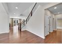 Bright living room boasts hardwood floors, staircase and open floor plan to the kitchen at 12762 Fisher St, Englewood, CO 80112