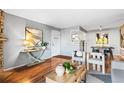Bright living room featuring hardwood floors, modern decor, and an open layout into the dining area at 8600 E Alameda Ave # 13-108, Denver, CO 80247
