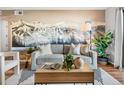 Comfortable living room with modern decor, a mountain mural and lots of natural light at 8600 E Alameda Ave # 13-108, Denver, CO 80247