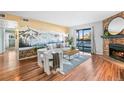 Spacious living room with fireplace, mountain mural and sliding glass doors at 8600 E Alameda Ave # 13-108, Denver, CO 80247