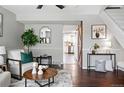 Bright living room showcasing hardwood floors and a sliding barn door that leads to the kitchen at 2113 Coronado Pkwy # B, Denver, CO 80229