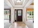 Inviting foyer featuring neutral tile flooring and a modern front door with sidelight at 10601 E Crestline Ave, Englewood, CO 80111