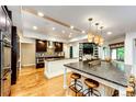 Spacious kitchen features hardwood floors, large islands, and modern lighting at 10601 E Crestline Ave, Englewood, CO 80111