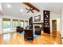Bright living room features wood floors, vaulted ceiling, fireplace, and built-in shelves at 10601 E Crestline Ave, Englewood, CO 80111