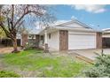 Charming single-story home featuring a brick and white painted exterior and an attached two-car garage at 18830 E 16Th Pl, Aurora, CO 80011