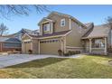 Charming two-story home featuring a three car garage, brick accents and well maintained lawn at 3080 Madison Ln, Broomfield, CO 80023