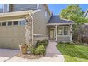 Delightful home with a charming covered porch, beautiful landscaping, and a two-car garage at 3080 Madison Ln, Broomfield, CO 80023