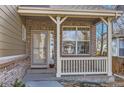 Charming front porch featuring brick accents, neutral siding, and a cozy entryway at 3080 Madison Ln, Broomfield, CO 80023
