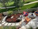 Outdoor patio with lounge chairs and stone firepit, overlooking landscaped yard and walkway at 3080 Madison Ln, Broomfield, CO 80023